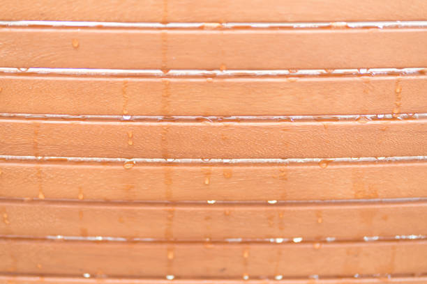 Close up of raindrops on a city park bench