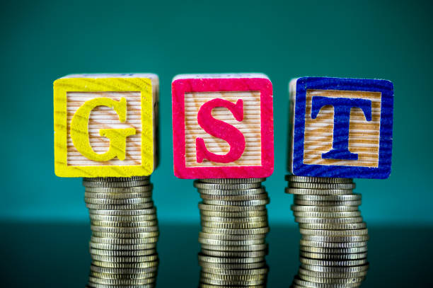 istock Finance Concept with Stack of Coins - GST alphabet arrangement (Good and Services Tax). 913234166