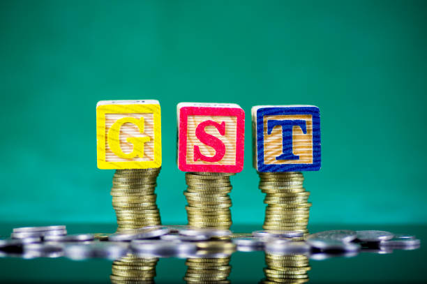 istock Finance Concept with Stack of Coins - GST alphabet arrangement (Good and Services Tax). 913234172