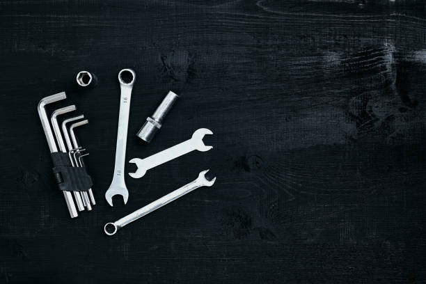 istock Tools for work or repair auto on black wooden background. Top view 913238178