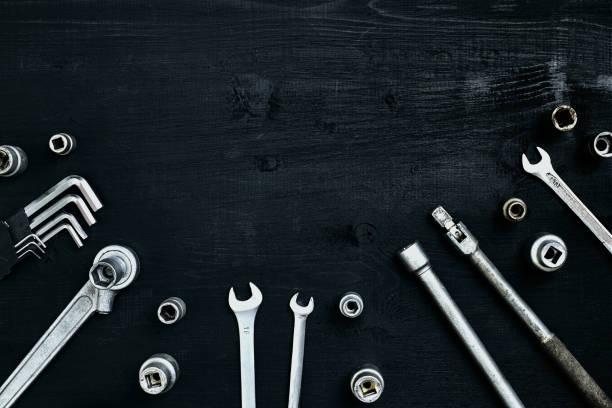 istock Tools for work or repair auto on black wooden background. Top view 913241214