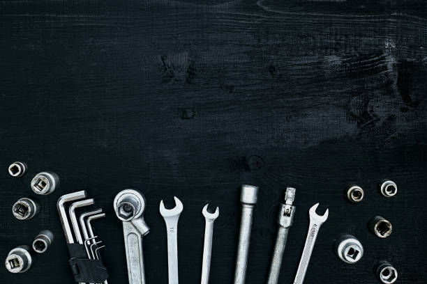 istock Tools for work or repair auto on black wooden background. Top view 913241322