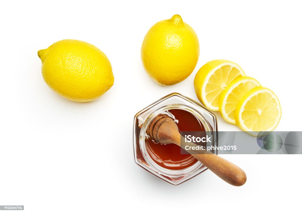 Honey and fresh lemon over white background Honey Stock Photo