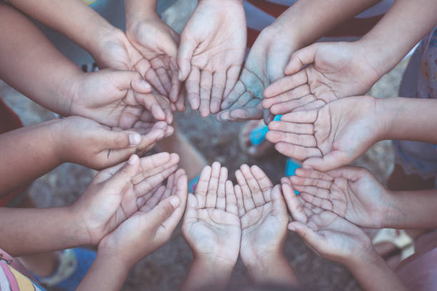 istock Group of children's open hands together with unity and teamwork 913245542