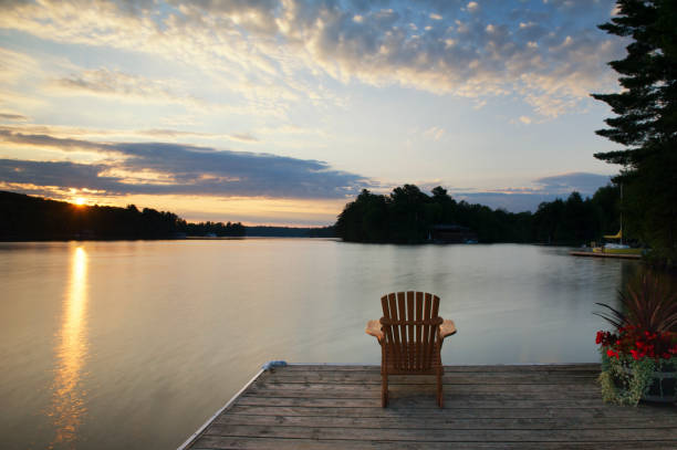 istock Muskoka chair on a dock at sunrise 913246076