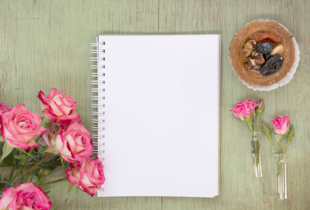 istock Blank notebook mock up for artwork with pink roses and cake. Place for text. Fresh flower. 913248546