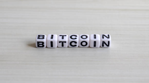 istock BITCOIN cube alphabet on the soft wood background. 913250658