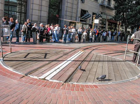San Francisco, Ca: People in line near railway turntable for cable cars at Powell street on Nov 12, 2007 in San Francisco.  This mechanical public transport is in service since 1873.
