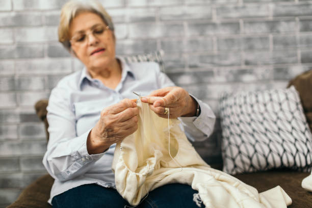 istock Senior woman is knitting sweather 913264962