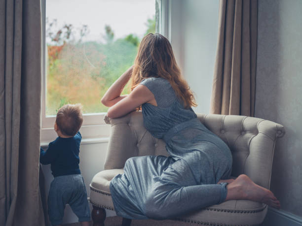 istock Mother and child looking out the window 913268376