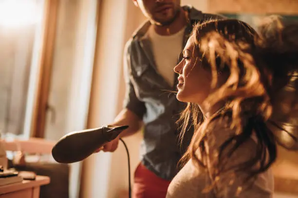 Happy woman enjoying in hair treatment at hairdresser's.