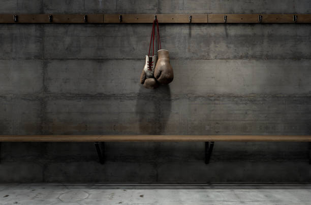 istock Worn Vintage Boxing Gloves Hanging In Change Room 913271476