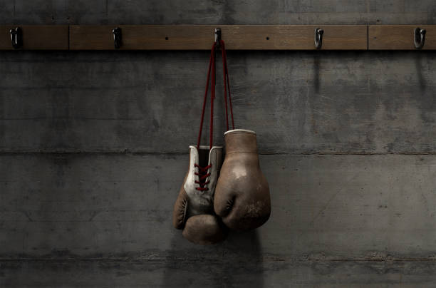 istock Worn Vintage Boxing Gloves Hanging In Change Room 913271516