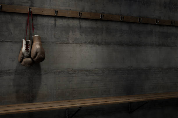 istock Worn Vintage Boxing Gloves Hanging In Change Room 913271664
