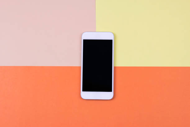 istock Blank smart phone on cream, yellow and orange background. 913271958