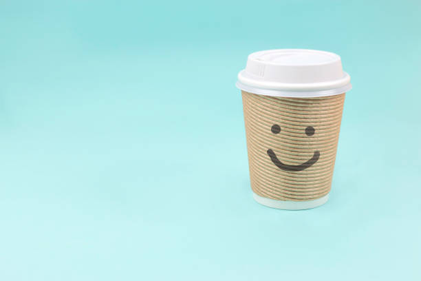 istock Take out paper coffee cup with smiling face on blue background. 913271964