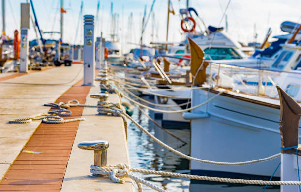 Yachts moored on harbour in Porto Colom on Majorca island, Spain Sailing boats moored at the pier in Portocolom on Mallorca, Spain Balearic islands mooring line stock pictures, royalty-free photos & images