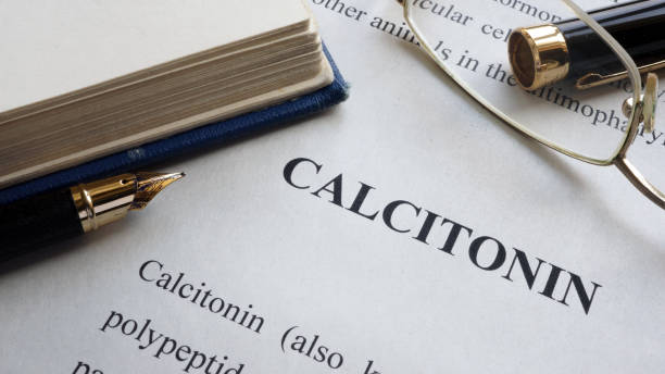 istock Paper with word Calcitonin and a book. 913276082
