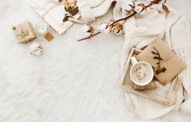 Winter cozy background with cup of coffee, warm sweater and old letters. Flat lay for bloggers