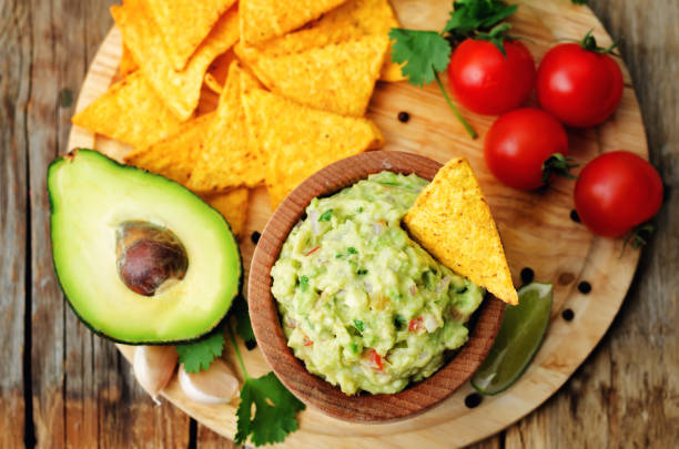 istock Guacamole with corn chips and ingredients to prepare it 913280886