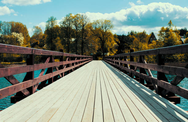 A bridge crossing a lake into paradise. stock photo