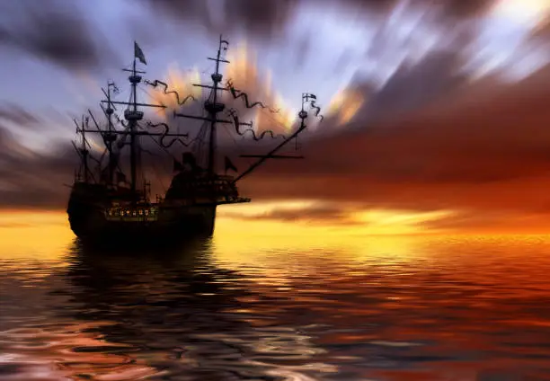 The ancient ship in the sea at sunset