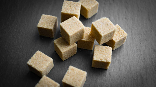 istock sugar cubes on a dark background. close up view 913292774