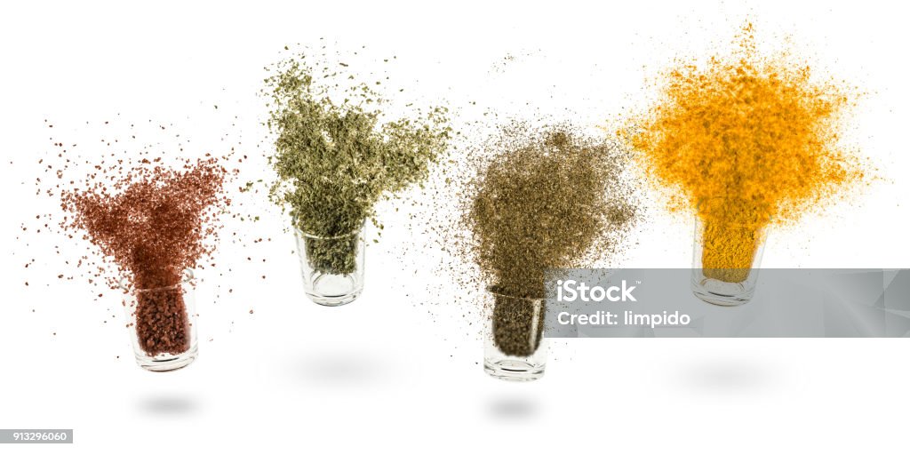 spices glass jars with various spices flying on white background Spice Stock Photo