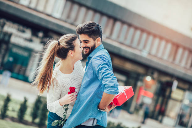Man surprising his girlfriend with a gift. Man surprising his girlfriend with a gift.Young man with giftbox closing his girlfriend eyes to make a surprise for her. gift for girlfriend stock pictures, royalty-free photos & images