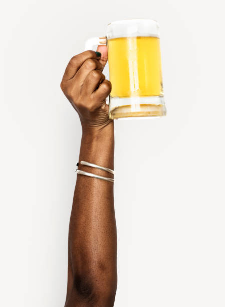 Black hand holding a glass of beer