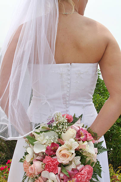istock Bride in wedding dress with flowers and veil 91330270