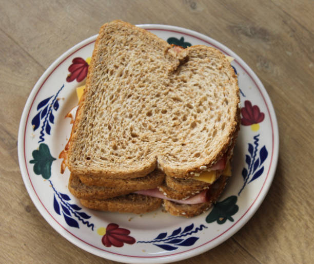 Two ham and cheese sandwich on plate stock photo