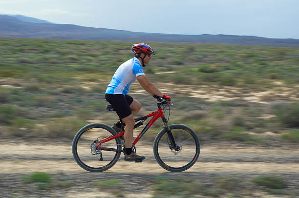 istock Mountain biker on old road in desert 91331068