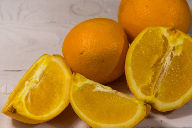 istock Fresh oranges on white wooden table 913311514