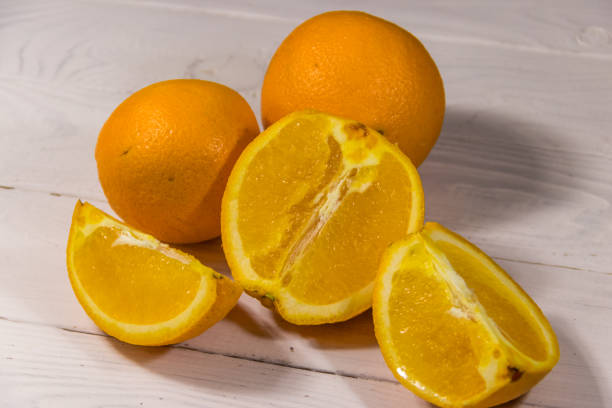 istock Fresh oranges on white wooden table 913311530