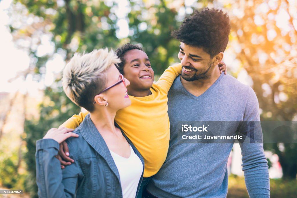 Happy young mixed race couple spending time with their daughter Family Stock Photo