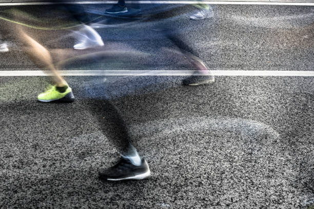 istock People running in marathon on city streets. Motion blur. 913314870