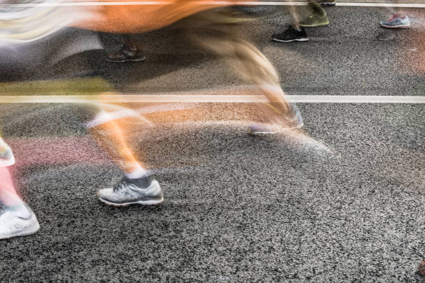 istock People running in marathon on city streets. Motion blur. 913314930