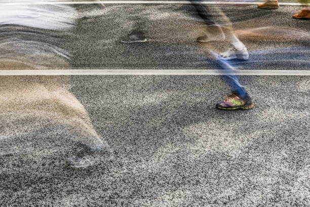 istock People running in marathon on city streets. Motion blur. 913314974