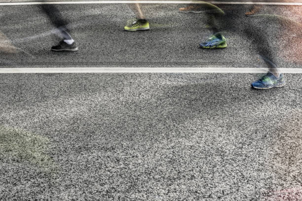 istock People running in marathon on city streets. Motion blur. 913314976