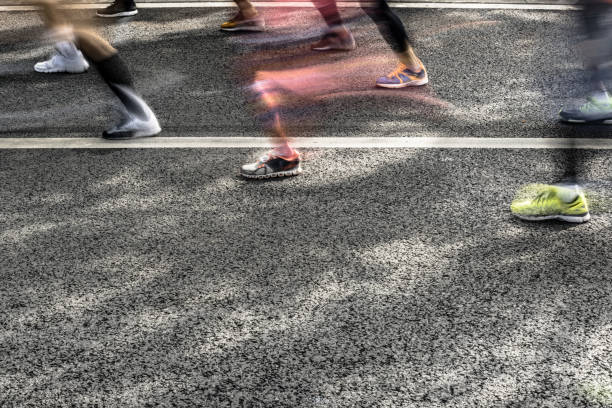 istock People running in marathon on city streets. Motion blur. 913315006