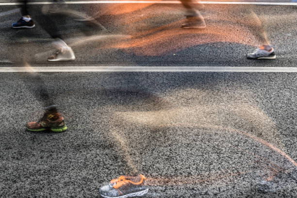 istock People running in marathon on city streets. Motion blur. 913315042