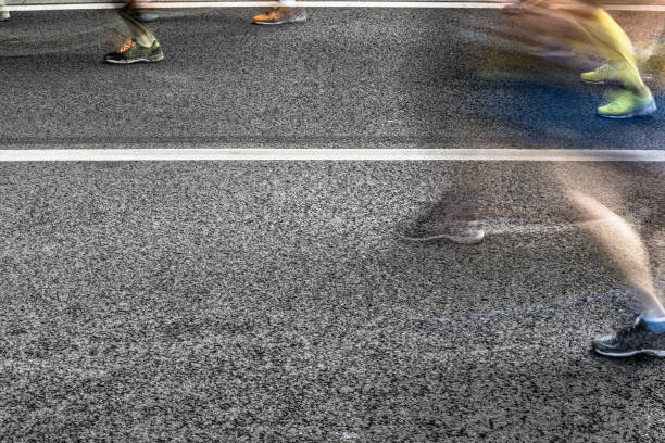 istock People running in marathon on city streets. Motion blur. 913315048