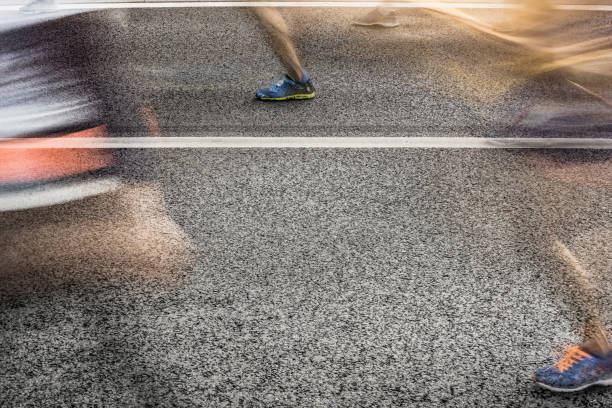 istock People running in marathon on city streets. Motion blur. 913315064
