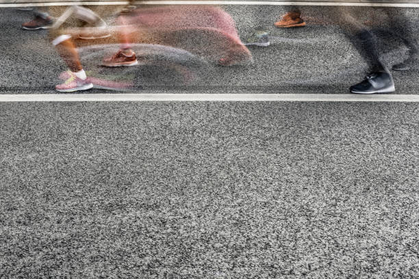 istock People running in marathon on city streets. Motion blur. 913315078