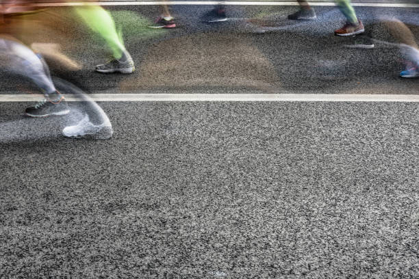 istock People running in marathon on city streets. Motion blur. 913315080