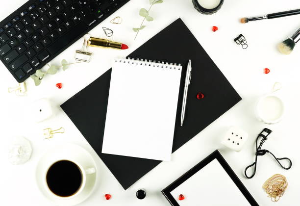 istock Flat lay home office desk. Women workspace with keyboard, cup of coffee, notebook, make up accessories on white background. 913316048