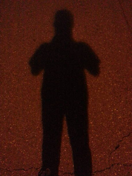 istock Man's shadow on the colored concrete ground 913316350
