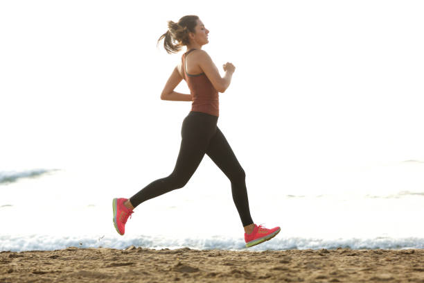 istock Full length beautiful female jogger on beach for workout routine 913320206