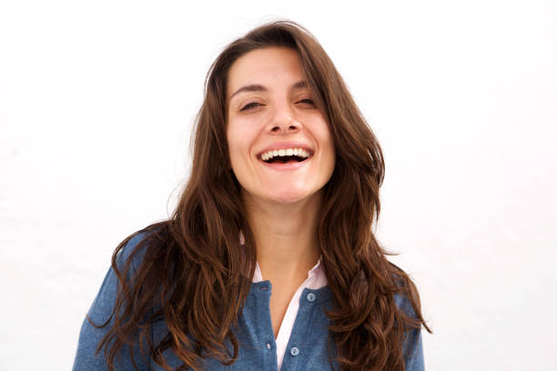 istock Close up beautiful woman laughing standing by white wall 913320360